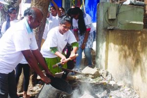 student volunteers cleaning up Jyoti Nivas College road in Koramangala as part of Namma Swachha Koramangala drive on Thursday.